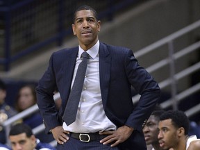 FILE - In this Feb. 7, 2018, file photo, Connecticut head coach Kevin Ollie watches from the sideline during the first half an NCAA college basketball game in Storrs, Conn. The University of Connecticut has announced it is self-imposing penalties, including the loss of a scholarship for the 2019-20 season, for violations of NCAA rules under former basketball coach Kevin Ollie, Friday, Jan. 18, 2019. The school said it also will restrict its recruiting and pay a fine of $5,000.
