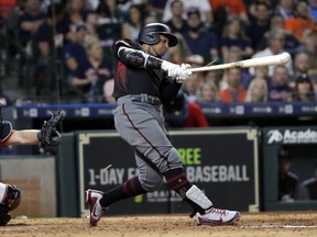 FILE - In this Sept. 14, 2018, file photo, Arizona Diamondbacks' Jon Jay, right, hits a triple to score Nick Ahmed as Houston Astros catcher Brian McCann looks on at left, during the eighth inning of a baseball game, in Houston. The Chicago White Sox and free-agent outfielder Jon Jay have finalized a $4 million, one-year contract. The 33-year-old Jay played for Kansas City and Arizona last season, batting .268 with three homers and 40 RBIs in 143 games.