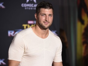 FILE - In this Tuesday, Oct. 10, 2017 file photo, Tim Tebow arrives at the world premiere of "Thor: Ragnarok" at the El Capitan Theatre in Los Angeles. Former Denver Broncos and University of Florida quarterback Tim Tebow is engaged. The Heisman Trophy winner announced his engagement on Instagram Thursday, Jan. 10, 2019 to Demi-Leigh Nel-Peters, a South Africa native and the 2017 Miss Universe.