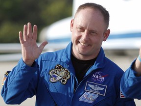 FILE - In this Tuesday, March 29, 2011 file photo, space shuttle Endeavour crew member Mike Fincke waves to onlookers after arriving for a practice countdown at Kennedy Space Center in Cape Canaveral, Fla. On Tuesday, Jan. 23, 2019, astronaut Eric Boe was pulled from the upcoming test flight for unspecified medical reasons, after more than three years of training. Taking his seat will be Fincke, a former space station commander.