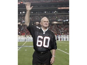 FILE - In this Sept. 20, 2009, file photo, former Atlanta Falcons Pro Bowler Tommy Nobis is introduced along with other members of the 1966 inaugural team during halftime of an NFL football game against the Carolina Panthers in Atlanta. Nobis, a hard-hitting linebacker for Atlanta and the University of Texas who earned the nickname "Mr. Falcon," had the most severe form of chronic traumatic encephalopathy. And now, as Atlanta prepares to host the Super Bowl, the descent of the NFL upon their hometown is a reminder for his family of the impact, both good and bad, that football has had on them.