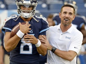 FILE - In this Aug. 30, 2018, file photo, Tennessee Titans quarterback Marcus Mariota (8) talks with offensive coordinator Matt LaFleur before a preseason NFL football game against the Minnesota Vikings in Nashville, Tenn. A person familiar with the decision says LaFleur has accepted Green Bay's offer to become the next head coach of the Packers.