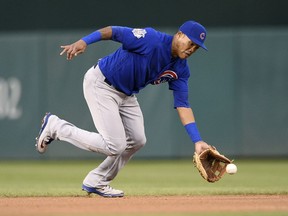 FILE - In this Sept. 8, 2018, file photo, Chicago Cubs shortstop Addison Russell fields a ground ball by Washington Nationals' Anthony Rendon during the fifth inning of the first baseball game of a doubleheader, Saturday, Sept. 8, 2018, in Washington. Russell and the Cubs have agreed to a $3.4 million, one-year contract, a relatively small $200,000 raise for a player whose relationship with the team appeared strained after a domestic violence suspension.