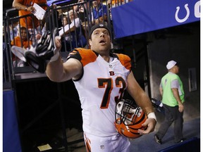 FILE - In this Sept. 3, 2015, file photo, Cincinnati Bengals' Eric Winston (73) throws his gloves to a fan following an NFL preseason football game against the Indianapolis Colts in Indianapolis. Avoiding a work stoppage in 2021 could depend on whether players can secure more guaranteed money in the next collective bargaining negotiations with the NFL. Winston says the best way to ensure more guaranteed money for players is to get them to free agency sooner.