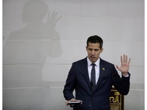 FILE - In this Jan. 5, 2019, file photo, Venezuelan lawmaker Juan Guaido takes the oath of office as president of the National Assembly in Caracas, Venezuela. A coalition of Latin American governments that joined the U.S. in quickly recognizing Guaido as Venezuela's interim president, and not Nicolas Maduro, came together during weeks of secret diplomacy.