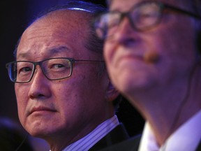 FILE- In this Nov. 6, 2018, file photo World Bank President Jim Yong Kim, left, and Bill Gates, former Microsoft CEO and co-founder of the Bill and Melinda Gates Foundation, listen to a speaker at the Reinvented Toilet Expo in Beijing. Kim, the president of the World Bank, says he is resigning at the end of January. Kim's unexpected departure nearly three years before his term was set to expire, is likely to set off a fierce battle between the Trump administration and other countries who have complained about the influence the United States exerts over the World Bank.