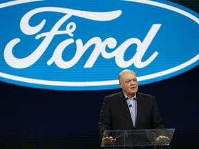 FILE- In this Jan. 14, 2018, file photo Ford President and CEO Jim Hackett prepares to address the media at the North American International Auto Show in Detroit. A new version of the Ford Explorer big SUV will be shown off at the auto show starting Monday, Jan. 14, 2019, and it will have an optional hybrid power system. It is Ford's first hybrid SUV in six years, and the company also has plans for a fully electric SUV based on the Mustang sometime next year. Seven battery-powered vehicles are planned for the U.S. by 2022, even a hybrid pickup truck.