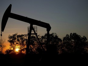 FILE - In this Feb. 19, 2015 file photo, the sun sets behind an oil well in a field near El Tigre, a town within Venezuela's Hugo Chavez oil belt, formally known as the Orinoco Belt. Venezuelan oil exports to the U.S. have declined steadily over the years, falling particularly sharply over the past decade as its production plummeted amid its long economic and political crisis.