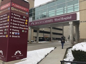 FILE - In this Jan. 15, 2019 file photo, the main entrance to Mount Carmel West Hospital is shown in Columbus, Ohio. The Columbus-area Mount Carmel Health System said a doctor's orders for potentially fatal doses of pain medicine given to over two dozen patients were carried out by what he calls "a small number of good people who made poor decisions." Mount Carmel Health System said it fired the intensive care doctor, put six pharmacists and 14 nurses on paid leave pending further review and reported its findings to authorities.