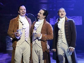 This image released by NBC shows Jimmy Fallon, host of "The Tonight Show Starring Jimmy Fallon," left, with Lin-Manuel Miranda, center, and a member of the cast from the musical "Hamilton," at the Luis A. Ferré Performing Arts Center in San Juan, Puerto Rico. Fallon will join the cast in a performance of "The Story of Tonight" from the Tony-winning musical which will air on Fallon's show on Tuesday, Jan. 15.
