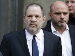 FILE - In this Thursday, Dec. 20, 2018, file photo, Harvey Weinstein, center, leaves New York Supreme Court in New York. Weinstein's lawyers say a New York judge should reject sex trafficking claims in a class-action civil lawsuit against the movie mogul. The lawyers said in papers filed late Monday, Jan. 28, that the law was aimed at stopping sex-trafficking rings or ventures that profit from the illicit sex trade.