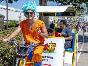 FILE - In this July 20, 2018 file photo, a pedicab driver dressed as a character from the anime franchise "Dragon Ball" gestures as he carries passengers during Comic-Con International in San Diego. "Dragon Ball" is a revered anime that has influenced pop culture for years, earning praise from the likes of Michael B. Jordan, Ronda Rousey and Chris Brown, showing up in end zone celebrations and even at the Macy's Thanksgiving Day Parade. With the new film "Dragon Ball Super: Broly" releasing this week in the U.S., the franchise's popularity with its famous and non-famous fans is likely to grow.