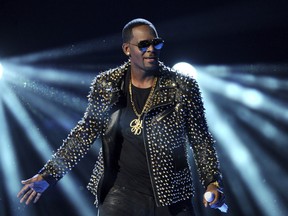 FILE - In this June 30, 2013 file photo, R. Kelly performs at the BET Awards in Los Angeles. A Georgia man involved with a recent documentary detailing abuse allegations against R. Kelly told police the singer's manager threatened him. A Stockbridge police report says Timothy Savage told an officer on Jan. 3 that Don Russell had texted him saying it would be best for him and his family if the documentary didn't air. Savage said he and his wife were involved with Lifetime's "Surviving R. Kelly" series.