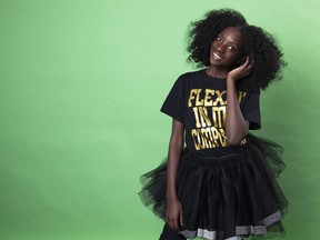 In this Dec. 19, 2018 photo, social media personality Kheris Rogers poses for a portrait in Los Angeles.  Rogers launched her own fashion line with T-shirts sporting, "Flexin' in My Complexion," along with backpacks reading "The Miseducation of Melanin" and other apparel and accessories.