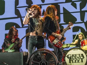 FILE - In this Dec. 8, 2018 file photo, Josh Kiszka, foreground left, and Jake Kiszka of Greta Van Fleet perform at the 2018 KROQ Absolut Almost Acoustic Christmas in Inglewood, Calif. The young Michigan rockers whose sound and classic rock look is reminiscent of Led Zeppelin are nominated for four Grammy Awards.