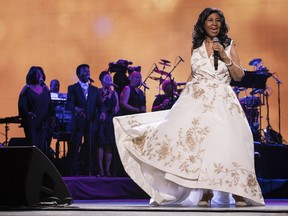 FILE - In this April 19, 2017, file photo, Aretha Franklin performs at the world premiere of "Clive Davis: The Soundtrack of Our Lives" at Radio City Music Hall, during the 2017 Tribeca Film Festival, in New York. The long-gesticulating Franklin biopic "Respect" is going ahead with stage director Liesel Tommy set to direct.