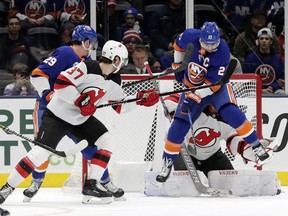 New York Islanders' Anders Lee (27) deflects the puck past New Jersey Devils goaltender Mackenzie Blackwood for a goal during the first period of an NHL hockey game, Thursday, Jan. 17, 2019, in Uniondale, N.Y.