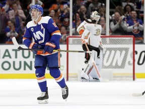New York Islanders' Cal Clutterbuck (15) skates past Anaheim Ducks goaltender Chad Johnson after scoring a goal during the first period of an NHL hockey game Sunday, Jan. 20, 2019, in Uniondale, N.Y.