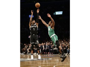Brooklyn Nets' D'Angelo Russell (1) shoots over Boston Celtics' Brad Wanamaker (9) during the first half of an NBA basketball game Monday, Jan. 14, 2019, in New York.