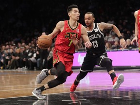 Atlanta Hawks' Jeremy Lin (7) drives past Brooklyn Nets' Shabazz Napier (13) during the first half of an NBA basketball game Wednesday, Jan. 9, 2019, in New York.