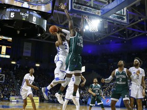 Buffalo guard jayvon Graves (3) is defended by Eastern Michigan center Boubacar Youre (12) during the first half of an NCAA college basketball game, Friday, Jan. 18, 2019, in Buffalo N.Y.