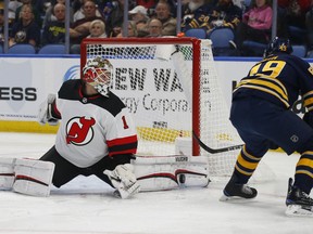 Buffalo Sabres forward C.J. Smith (49) is stopped by New Jersey Devils goalie Keith Kinkaid (1) during the first period of an NHL hockey game, Tuesday, Jan. 8, 2019, in Buffalo N.Y.