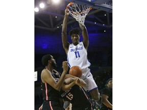 Buffalo forward Jeenathan Williams (11) dunks against Ball State during the first half of an NCAA college basketball game, Tuesday, Jan. 29, 2019, in Buffalo N.Y.