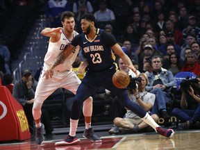FILE- In this Jan. 14, 2019, file photo New Orleans Pelicans' Anthony Davis, right, dribbles against Los Angeles Clippers' Danilo Gallinari during the first half of an NBA basketball game in Los Angeles. Davis' agent says the five-time All-Star has told the New Orleans Pelicans that he wants to be traded to a contending team. Agent Rich Paul confirmed the request to The Associated Press early Monday, Jan. 28.
