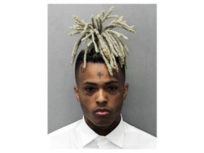 FILE - This undated photo released by the Miami-Dade Corrections & Rehabilitation Department shows rapper XXXTentacion. Seven months after XXXTentacion was murdered, the rapper-singer's son has been born. Jenesis Sanchez, XXXTentacion's girlfriend, on Saturday gave birth to baby boy Gekyume Onfroy. The birth was announced Saturday, Jan. 26, 2019, by XXXTentacion's mother, Cleopatra Bernard. (Miami-Dade Corrections & Rehabilitation Department via AP, File)