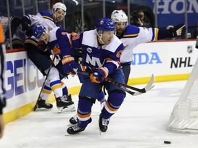 New York Islanders center Casey Cizikas (53) takes the puck from St. Louis Blues left wing Pat Maroon (7) during the first period of an NHL hockey game, Tuesday, Jan. 15, 2019, in New York.