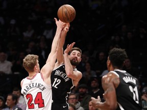 Chicago Bulls forward Lauri Markkanen (24) defends as Brooklyn Nets forward Joe Harris (12) looks to pass to Nets guard Treveon Graham (21) during the first half of an NBA basketball game Tuesday, Jan. 29, 2019, in New York.