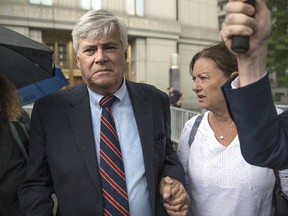 FILE - In this July 17, 2018, file photo, former Republican New York state Senate leader Dean Skelos and his wife, Gail, right, leave federal court in New York after he and his son Adam were convicted on charges of extortion, wire fraud and bribery. On Tuesday Jan. 8, 2019, the elder Skelos is expected to report to the federal prison at Otisville, New York, to begin serving his prison sentence, while his son will report to the federal prison in Danbury, Connecticut, to begin serving his sentence.
