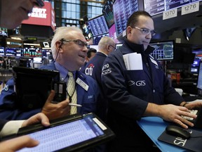 Trader James Dresch, center, and specialist Anthony Matesic, right, work on the floor of the New York Stock Exchange, Friday, Jan. 4, 2019. Stocks are jumping at the open on Wall Street Friday as investors welcome news of trade talks between the U.S. and China and a big gain in jobs in the U.S.