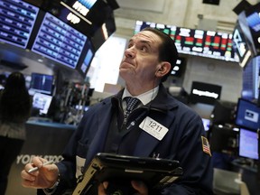 Trader Tommy Kalikas works on the floor of the New York Stock Exchange, Monday, Jan. 14, 2019. Stocks are opening lower on Wall Street after China reported a surprise drop in exports to the U.S. last month.