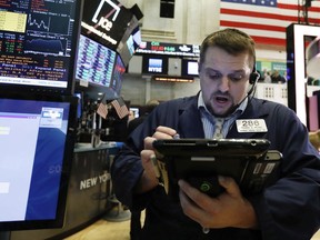 Trader Michael Milano works on the floor of the New York Stock Exchange, Tuesday, Jan. 29, 2019. Stocks are opening slightly higher on Wall Street as several big U.S. companies reported solid results for the latest quarter.