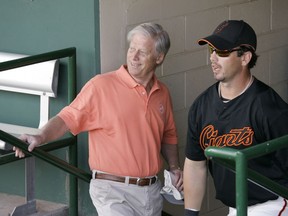 File-This March 1, 2008, file photo shows San Francisco Giants managing general partner Peter Magowan, left, visiting with center fielder Aaron Rowand, right, in the dugout prior to their spring training baseball game against the Oakland Athletics in Scottsdale, Ariz. The longtime San Francisco Giants owner has died at the age of 76. The team said Magowan died Sunday, Jan. 27, 2019, after a battle with cancer.