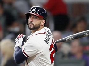 File-This Sept. 21, 2018, file photo shows Atlanta Braves right fielder Nick Markakis (22) batting against the Philadelphia Phillies during a baseball game in Atlanta. The Braves have agreed to one-year contract to bring back Markakis, a deal worth a guaranteed $6 million. Markakis' deal, announced Tuesday, Jan. 22, 2019, includes a $4 million salary this year and $6 million club option for 2020 with a $2 million buyout.