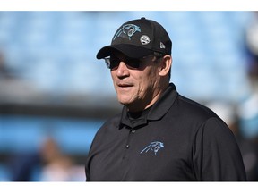 File-This Dec. 23, 2018, file photo shows Carolina Panthers head coach Ron Rivera watching his team warm up before an NFL football game against the Atlanta Falcons in Charlotte, N.C. With only a handful of minorities in the stepping-stone positions of offensive coordinator and quarterbacks coach, the NFL saw its sharpest-ever one-year drop in minority head coaches, causing concern among advocates for diversity declaring unsatisfactory progress 16 years after the Rooney Rule was implemented.