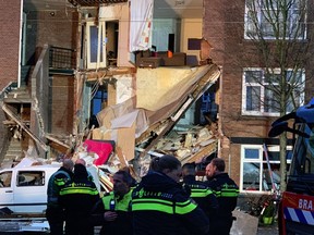 Authorities respond after a three-story home collapsed in The Hague, Netherlands on Sunday, Jan. 27, 2019. Police at the scene said a gas explosion was being explored as a possible cause of what tore off the home's front and demolished the dwelling in a residential neighborhood on Sunday.