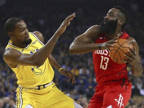 Golden State Warriors' Kevin Durant, left, defends against Houston Rockets' James Harden during the first half of an NBA basketball game Thursday, Jan. 3, 2019, in Oakland, Calif.