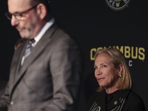 Dee Haslam, right, a member of the ownership group for Columbus Crew SC, listens as MLS commissioner Don Garber speaks during a Columbus Crew SC introductory press conference in Columbus, Ohio, Wednesday, Jan. 9, 2018.