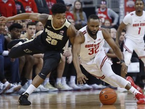 Purdue's Nojel Eastern, left, and Ohio State's Keyshawn Woods chase the ball during the first half of an NCAA college basketball game Wednesday, Jan. 23, 2019, in Columbus, Ohio.
