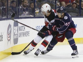 Columbus Blue Jackets' Markus Nutivaara, right, of Finland, checks New Jersey Devils' Pavel Zacha, of the Czech Republic, during the first period of an NHL hockey game Tuesday, Jan. 15, 2019, in Columbus, Ohio.