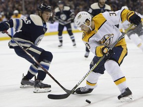 Nashville Predators' Viktor Arvidsson, right, of Sweden, steals the puck from Columbus Blue Jackets' Markus Nutivaara, of Finland, during the first period of an NHL hockey game Thursday, Jan. 10, 2019, in Columbus, Ohio.