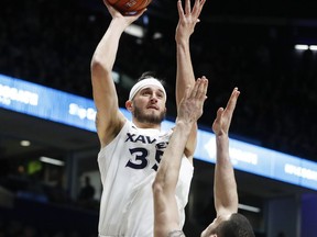 Xavier forward Zach Hankins (35) shoots over Seton Hall forward Sandro Mamukelashvili (23) during the first half of an NCAA college basketball game Wednesday, Jan. 2, 2019, in Cincinnati.