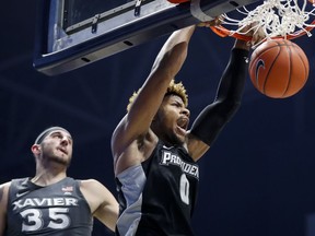 Providence's Nate Watson (0) dunks on Xavier's Zach Hankins (35) in the first half of an NCAA college basketball game, Wednesday, Jan. 23, 2019, in Cincinnati.