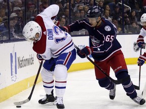 Montreal Canadiens forward Max Domi, left, controls the puck against Columbus Blue Jackets defenseman Markus Nutivaara, of Finland, during the first period of an NHL hockey game in Columbus, Ohio, Friday, Jan. 18, 2019.