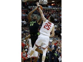 Michigan State forward Nick Ward, left, goes up for a shot against Ohio State forward Kyle Young during the first half of an NCAA college basketball game in Columbus, Ohio, Saturday, Jan. 5, 2019.