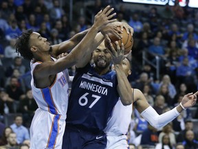 Minnesota Timberwolves forward Taj Gibson (67) is defended by Oklahoma City Thunder guard Terrance Ferguson, left, in the first half of an NBA basketball game in Oklahoma City, Tuesday, Jan. 8, 2019. Russell Westbrook is at right.