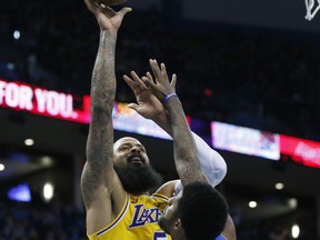 Los Angeles Lakers center Tyson Chandler (5) shoots over Oklahoma City Thunder forward Paul George (13) during the first half of an NBA basketball game in Oklahoma City, Thursday, Jan. 17, 2019.